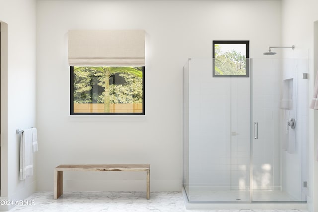 bathroom with a shower with door