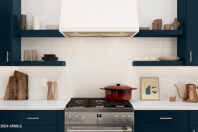 kitchen featuring tasteful backsplash, blue cabinetry, exhaust hood, and stainless steel gas range