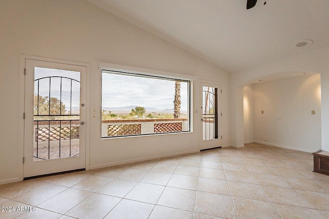 interior space featuring light tile patterned flooring, ceiling fan, and lofted ceiling