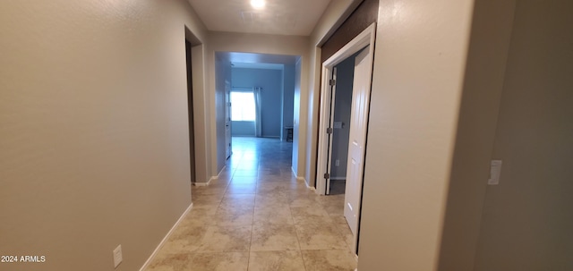 hall featuring light tile patterned floors