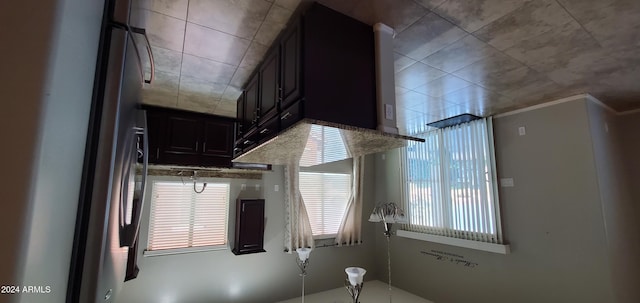 kitchen featuring dark brown cabinets and stainless steel refrigerator