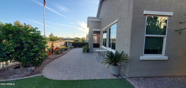 view of side of property featuring a patio