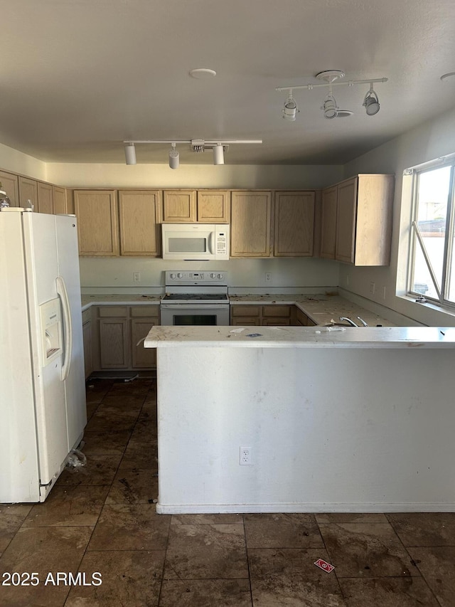 kitchen featuring white appliances, light brown cabinetry, track lighting, and light countertops