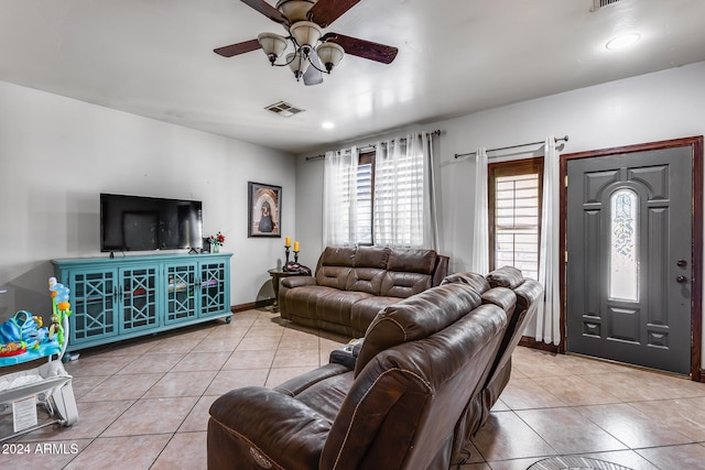 living room with light tile patterned floors and ceiling fan