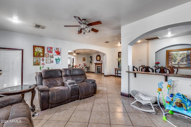 living room featuring light tile patterned floors and ceiling fan