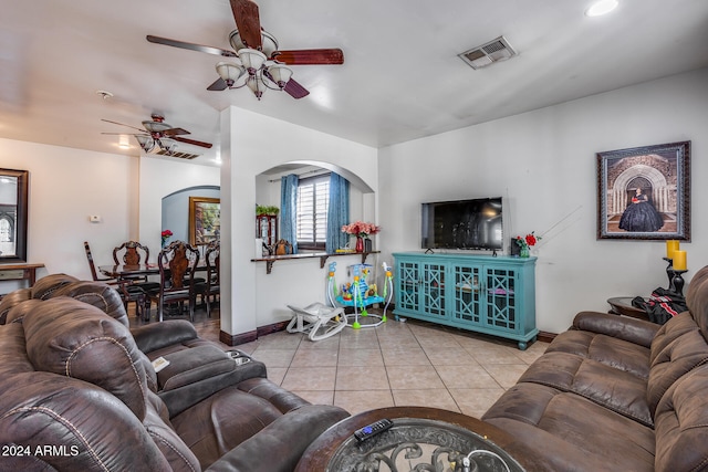 living room featuring light tile patterned floors and ceiling fan