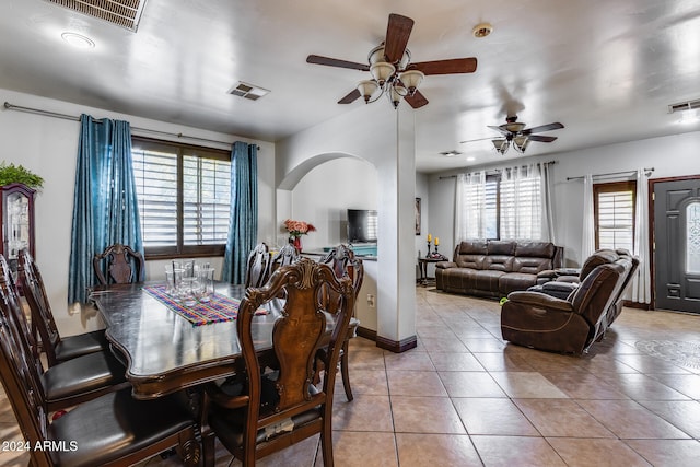 tiled dining space featuring a wealth of natural light and ceiling fan