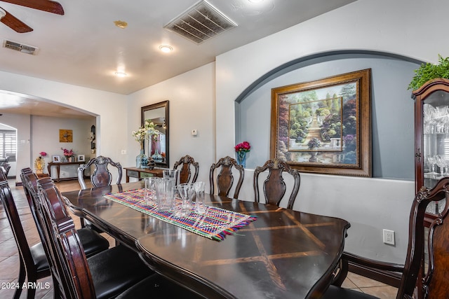 tiled dining area with ceiling fan