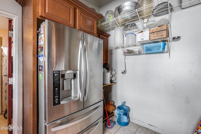 kitchen featuring light tile patterned floors and stainless steel fridge