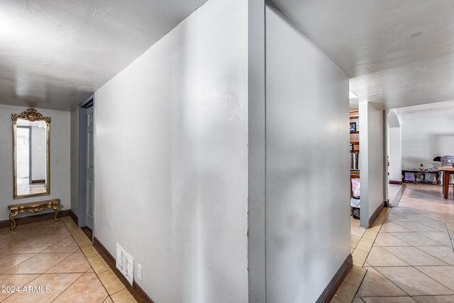 corridor with light tile patterned floors