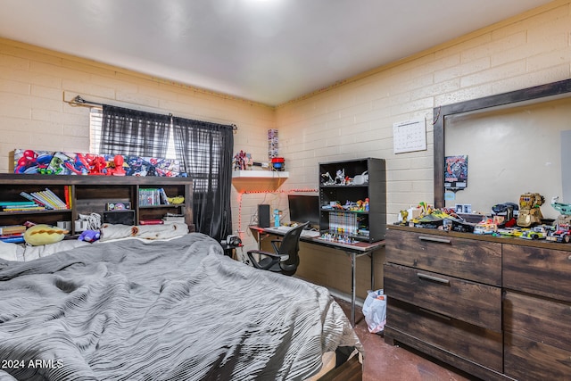 bedroom featuring brick wall