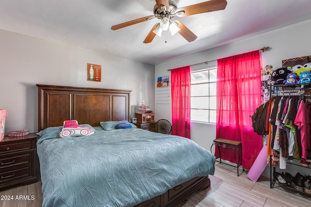 bedroom with light hardwood / wood-style flooring and ceiling fan