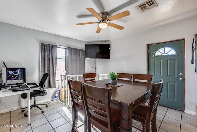 tiled dining room with ceiling fan