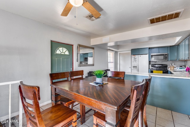 tiled dining space with ceiling fan