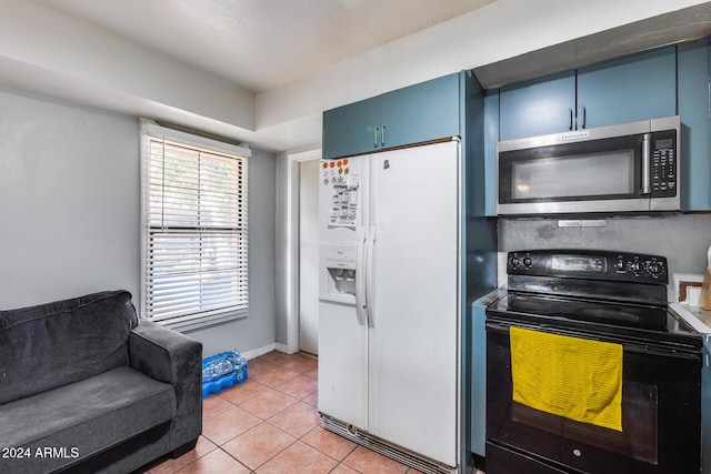 kitchen featuring blue cabinetry, black / electric stove, light tile patterned floors, and white fridge with ice dispenser