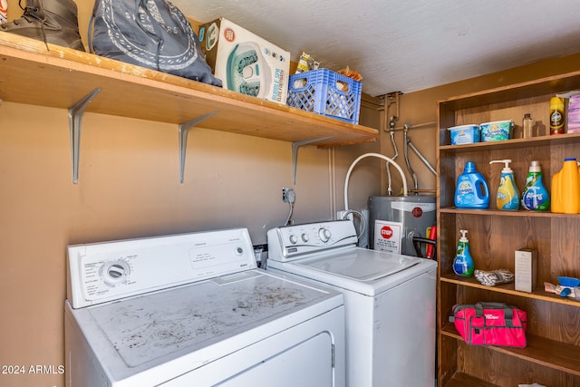 clothes washing area featuring water heater and independent washer and dryer