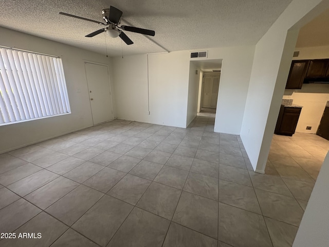 6605 N 46th Ln, Glendale, AZ 85301 - empty room featuring a textured ceiling, ceiling fan, and tile patterned floors