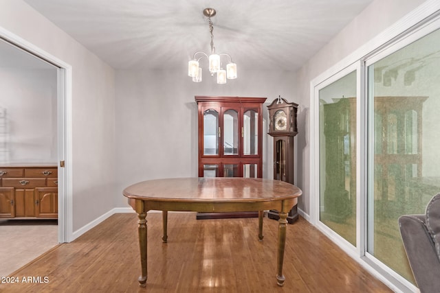 dining space featuring light hardwood / wood-style floors, a wealth of natural light, and a chandelier