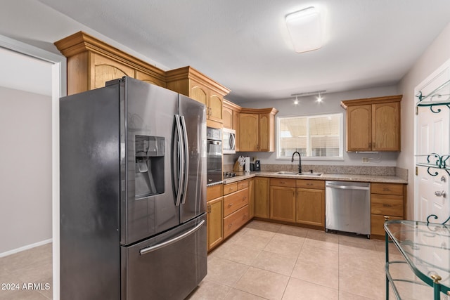 kitchen with sink, stainless steel appliances, and light tile patterned floors