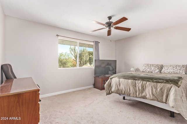 bedroom featuring light colored carpet and ceiling fan