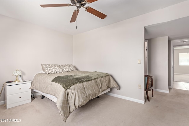 bedroom with ceiling fan and light carpet