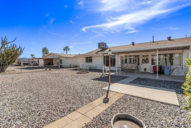 back of house with central AC and a patio