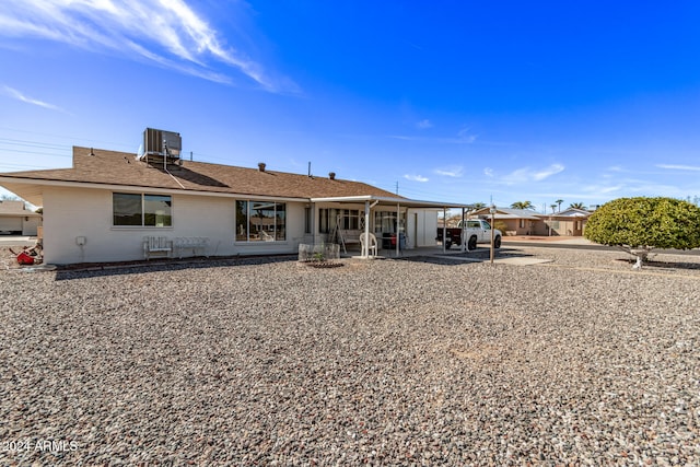 rear view of house featuring a patio area and central AC