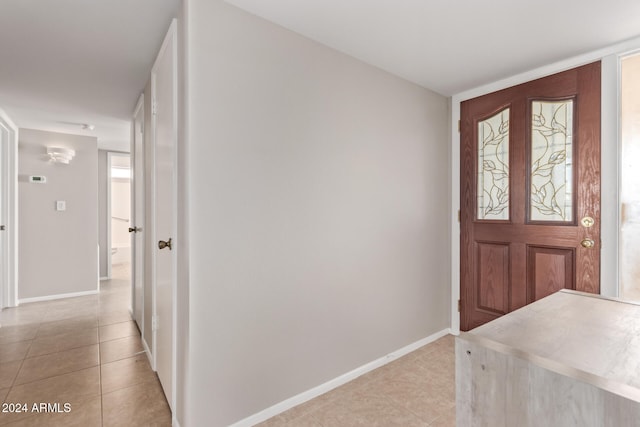 foyer entrance featuring light tile patterned flooring