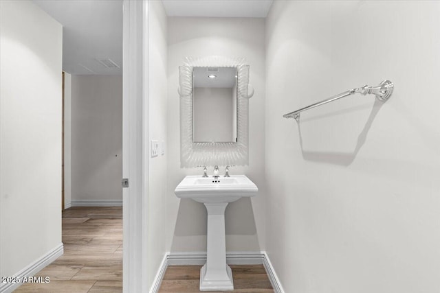 bathroom with hardwood / wood-style floors and sink