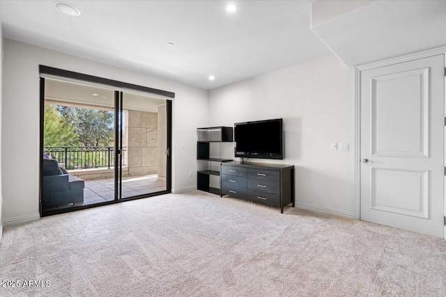 unfurnished living room with light colored carpet