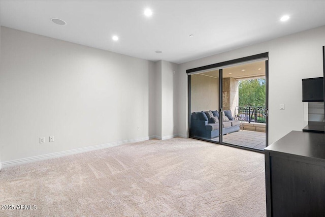 unfurnished living room with light colored carpet