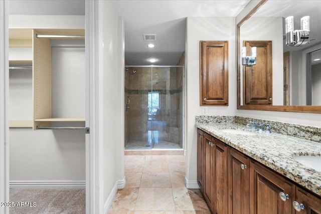 bathroom with vanity and a shower with shower door