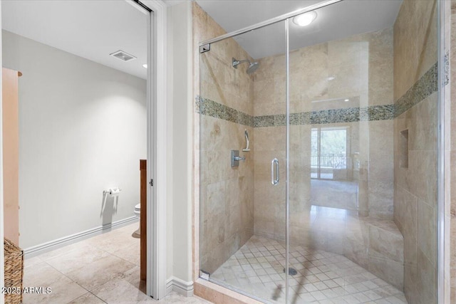 bathroom with tile patterned flooring, toilet, and walk in shower