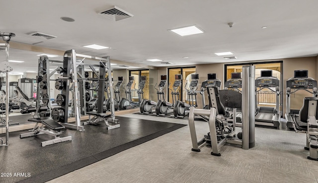 exercise room featuring light colored carpet