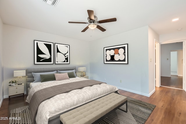 bedroom featuring wood finished floors, visible vents, ceiling fan, and baseboards