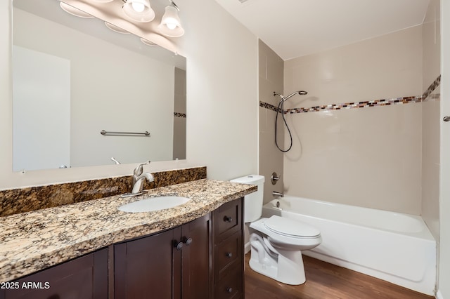 full bathroom with toilet, vanity, bathing tub / shower combination, and wood finished floors
