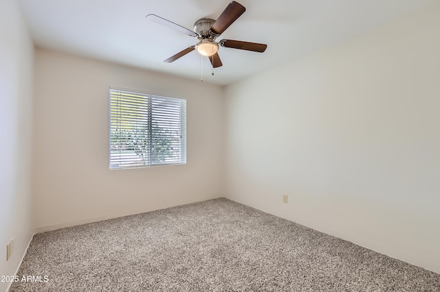 unfurnished room featuring a ceiling fan and carpet