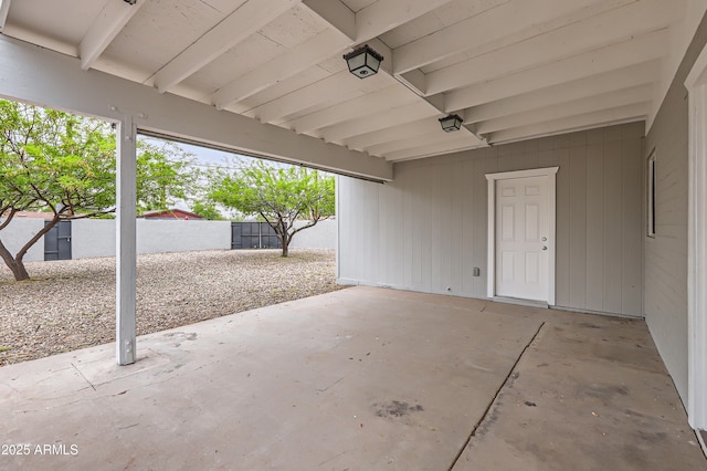 view of patio with fence and a carport