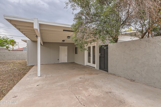 view of patio with a carport and french doors