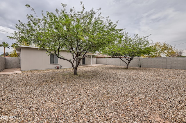 view of front of home featuring a fenced backyard and a patio area