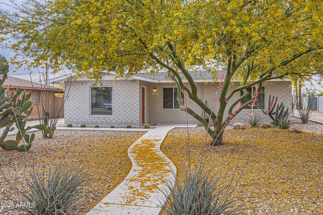 ranch-style home with brick siding and fence