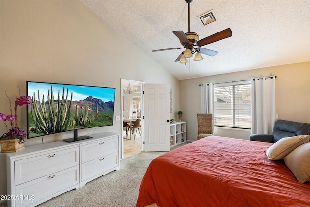 carpeted bedroom with vaulted ceiling, ceiling fan, and a textured ceiling