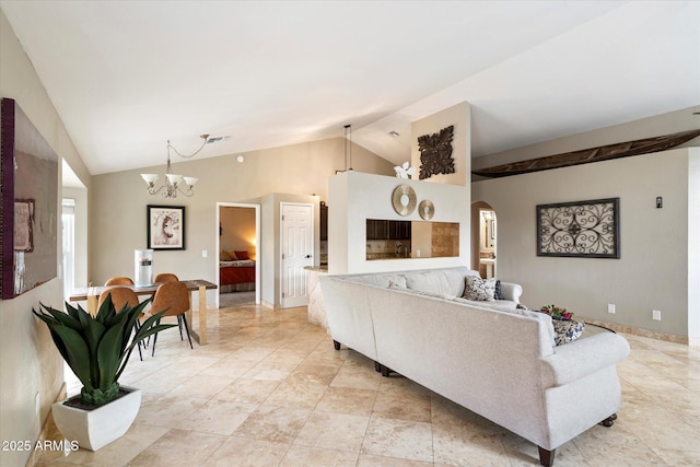 living room featuring a chandelier and vaulted ceiling