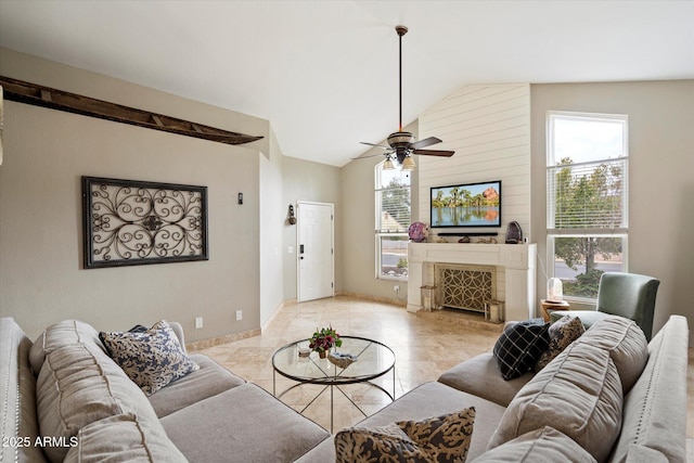 tiled living room featuring vaulted ceiling, a large fireplace, and ceiling fan