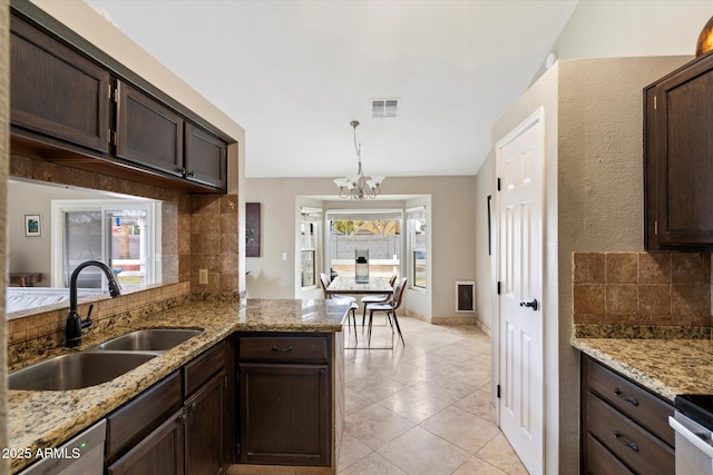 kitchen with sink, dark brown cabinets, and backsplash