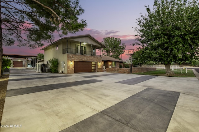 view of front of home with a balcony and a garage