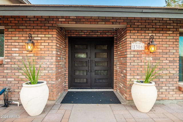 view of exterior entry with covered porch