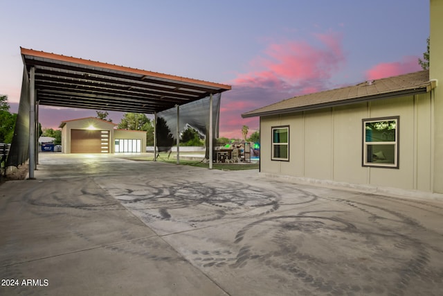 exterior space featuring a garage and an outbuilding