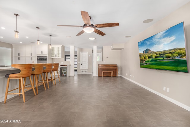 living room featuring beverage cooler and ceiling fan