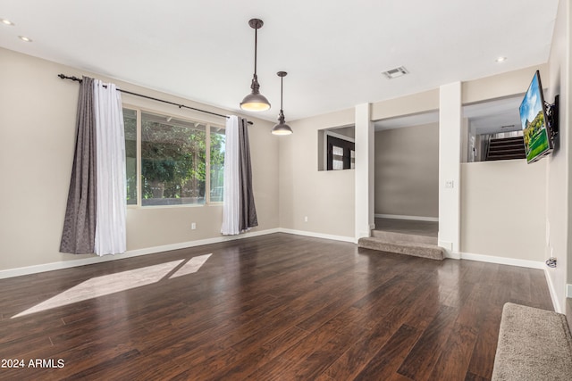 unfurnished living room with dark hardwood / wood-style floors